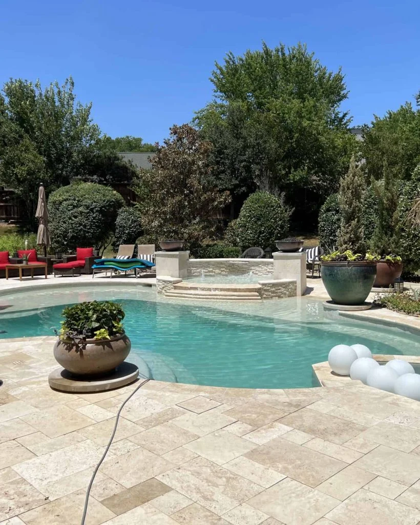 Beautiful backyard with custom pool plastering, outdoor seating, and lush landscaping enhancing pool appeal.